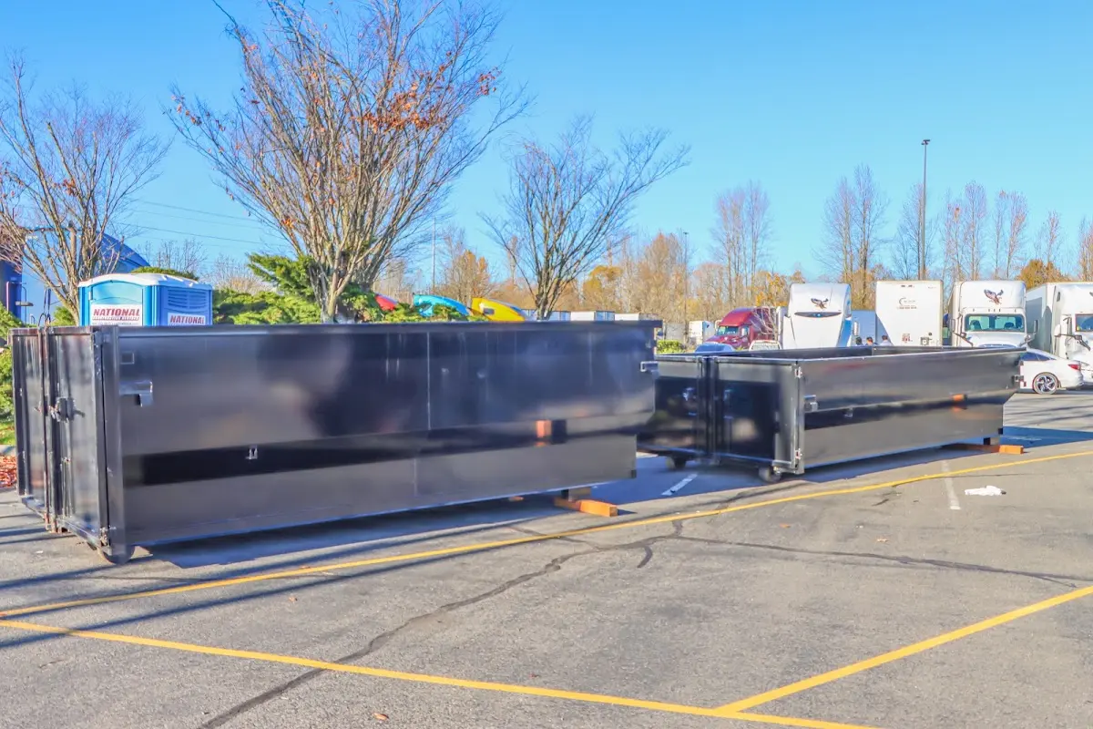 Professional dumpster rental service with roll-off container on residential driveway in Powder Springs